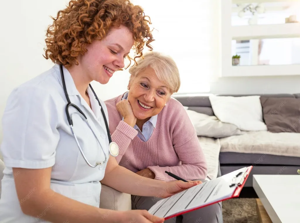 A nurse going through a clipboard with a resident.